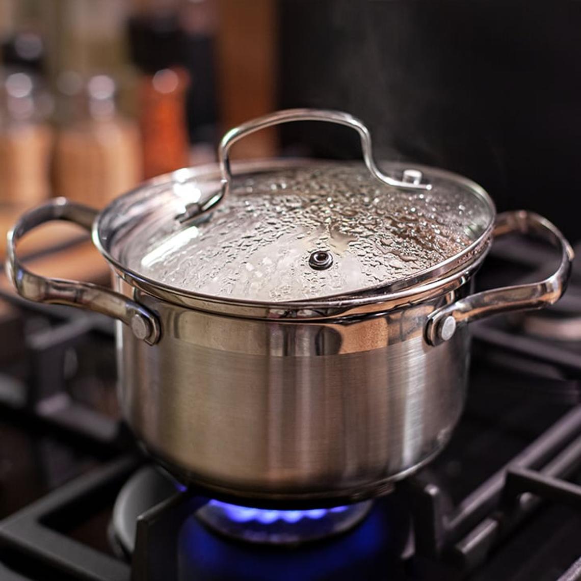 A saucepan on the hob with a lid on it