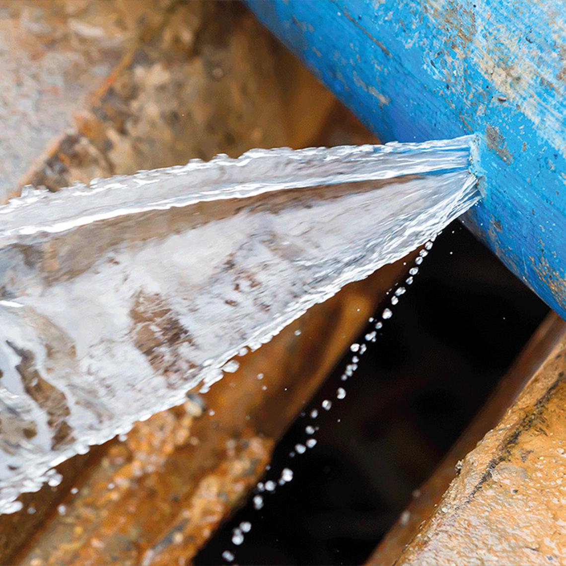 Photo of a blue water pipe with a leak