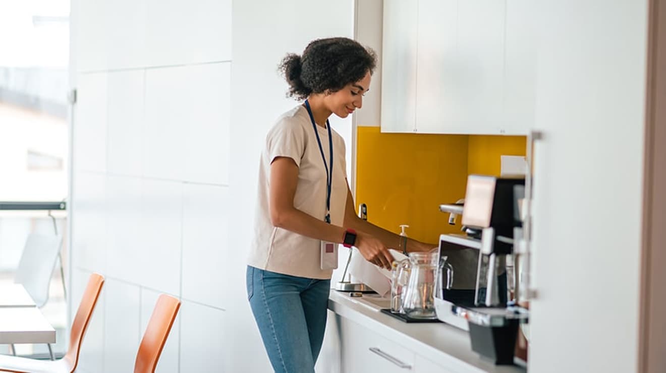 Woman making drink at work