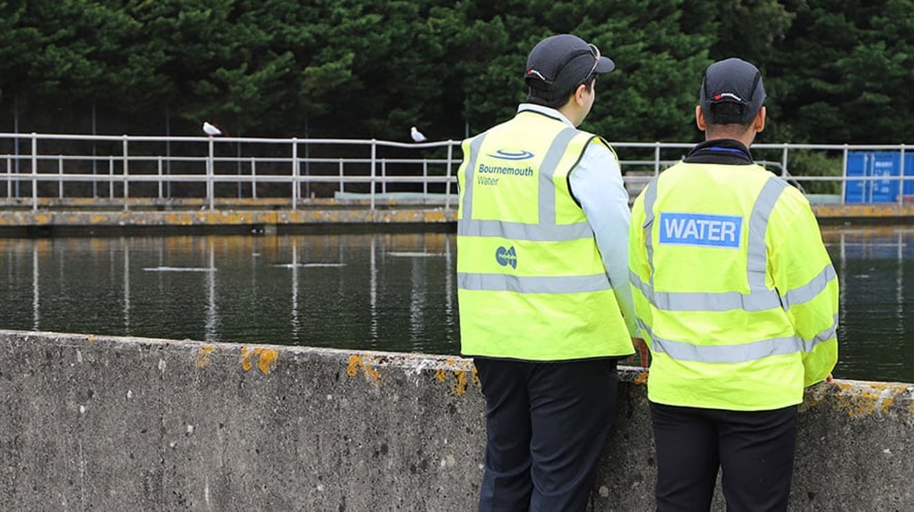 Two men overlooking water treatment facility