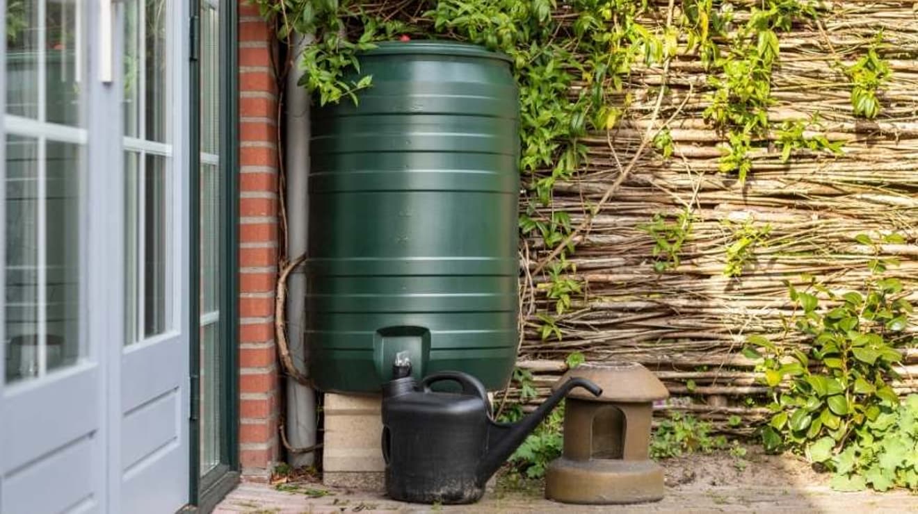 Water butt in garden on patio next to french doors