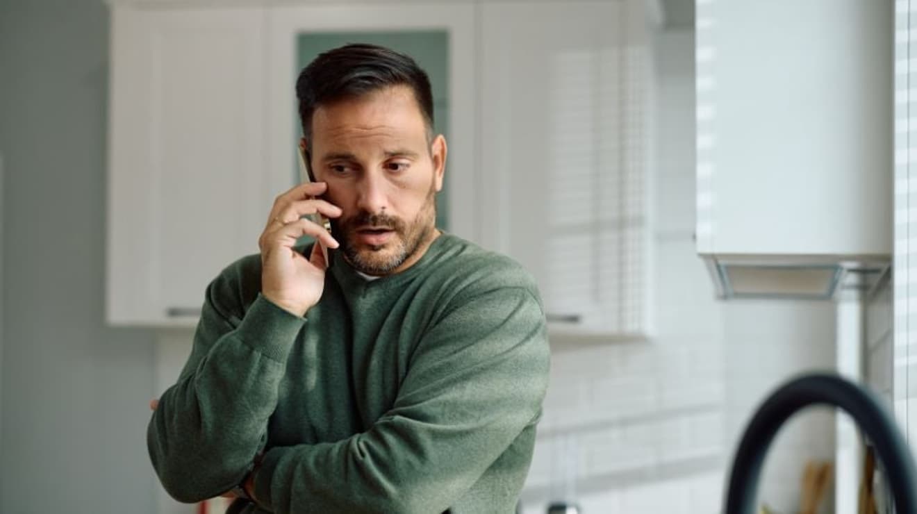 Man on the phone looking unhappy