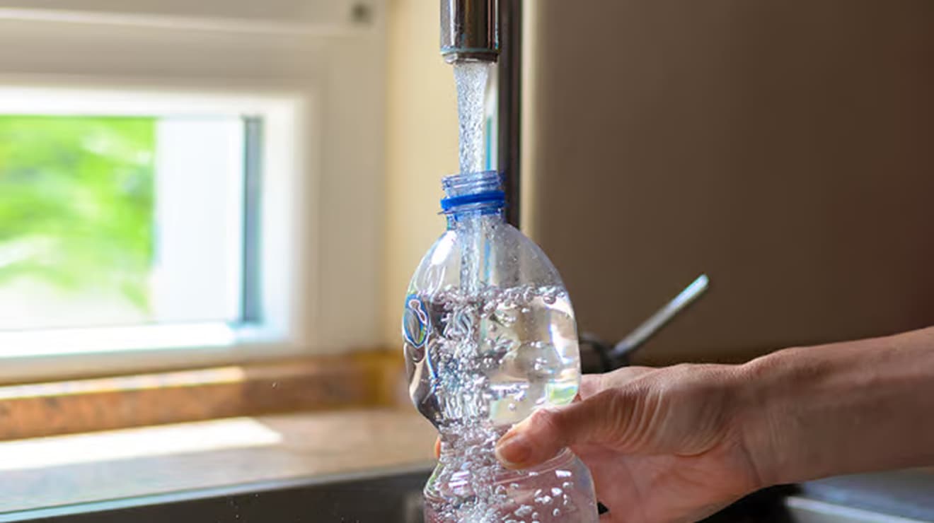 filling up water bottle from tap