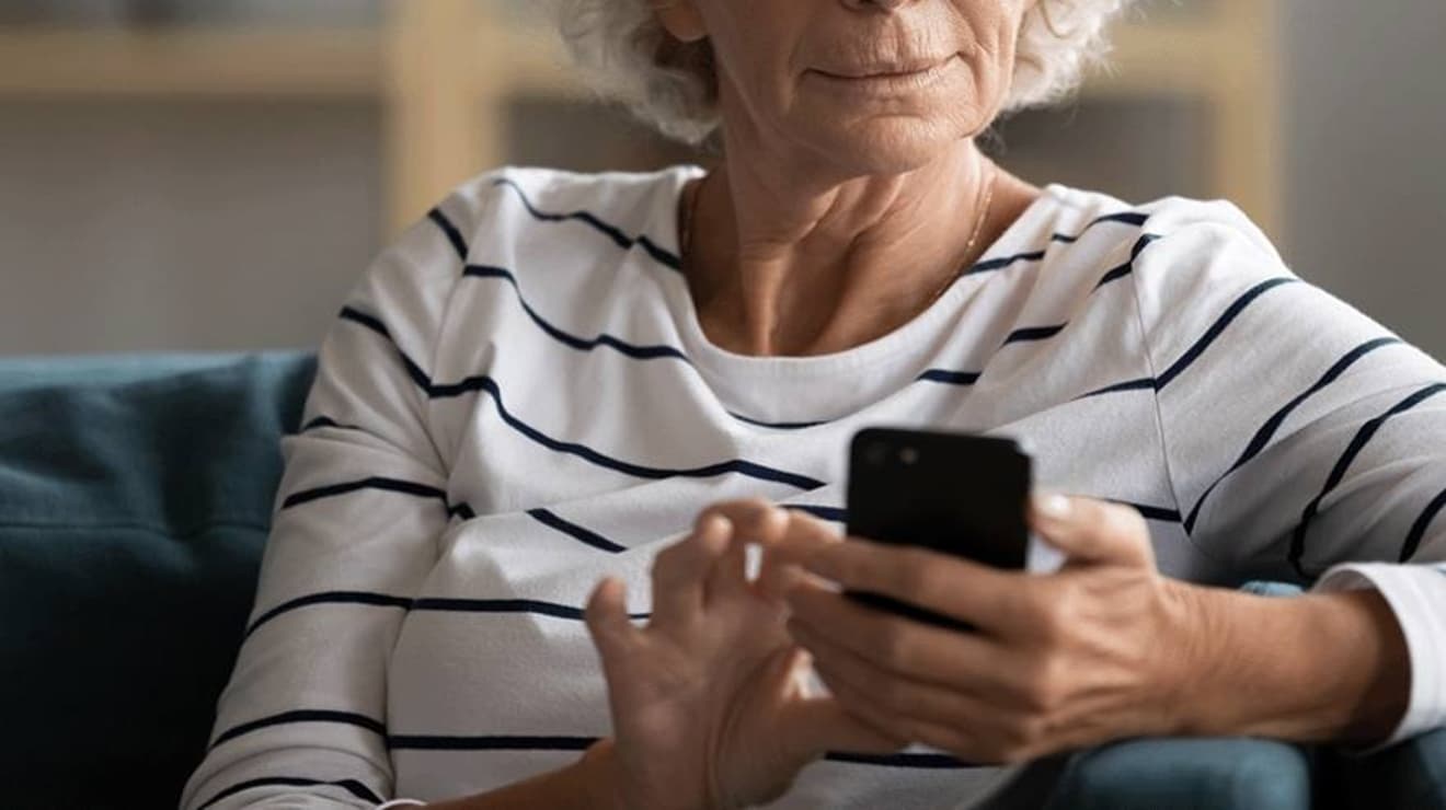 Lady sat on the sofa using MyAccount on her mobile phone