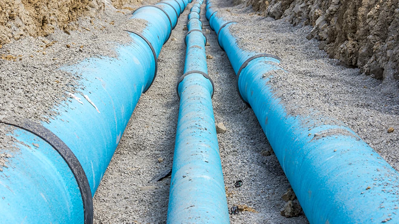 Exposed water main pipe in an open trench