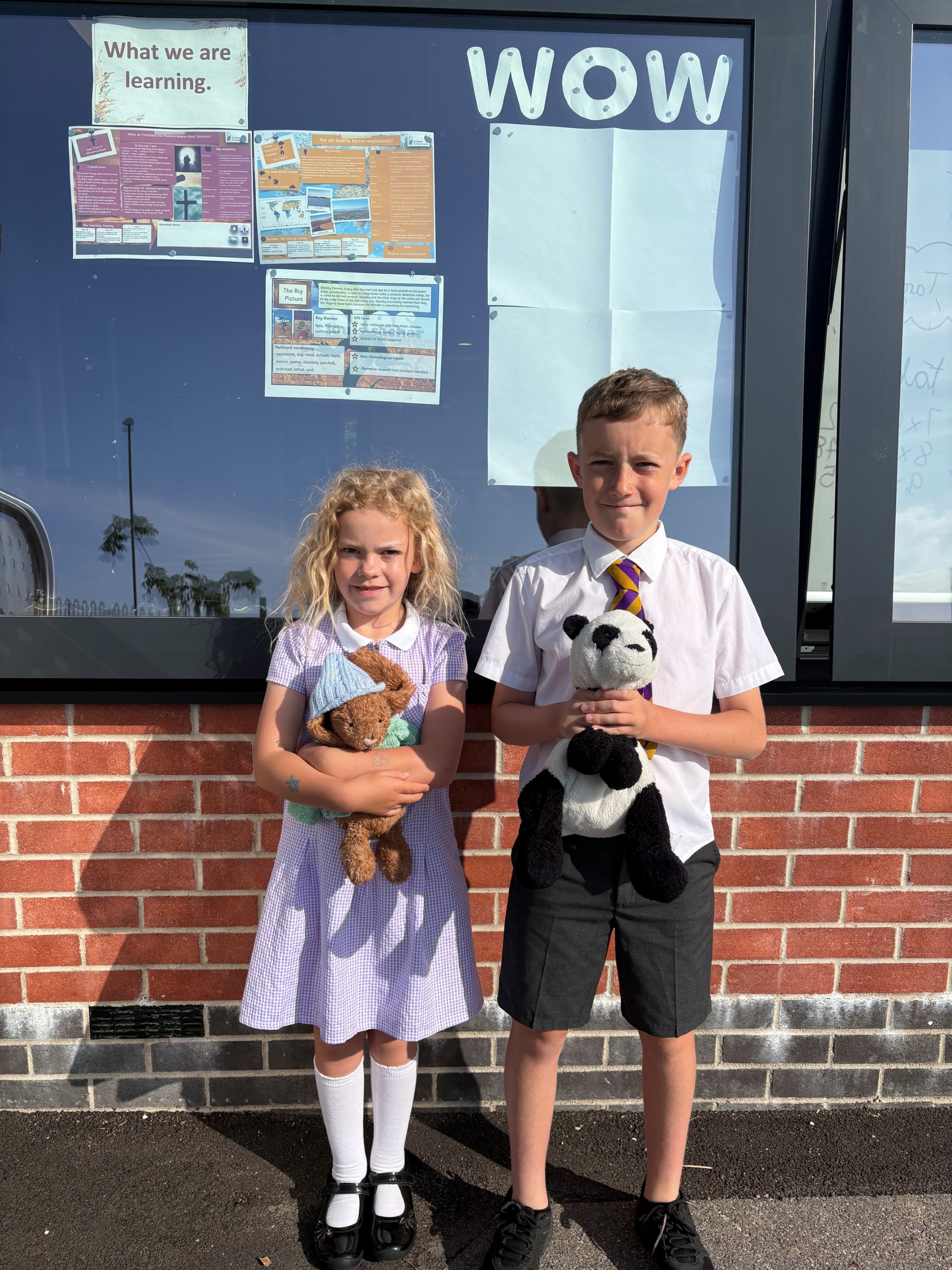 Girl and boy holding a cuddly toy