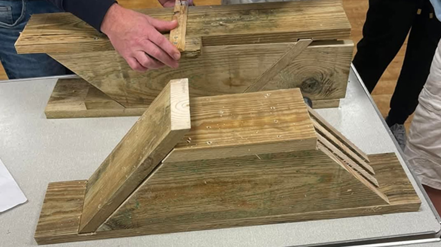 Close up of people making bat boxes