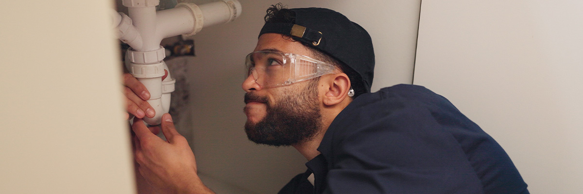 Plumber under sink